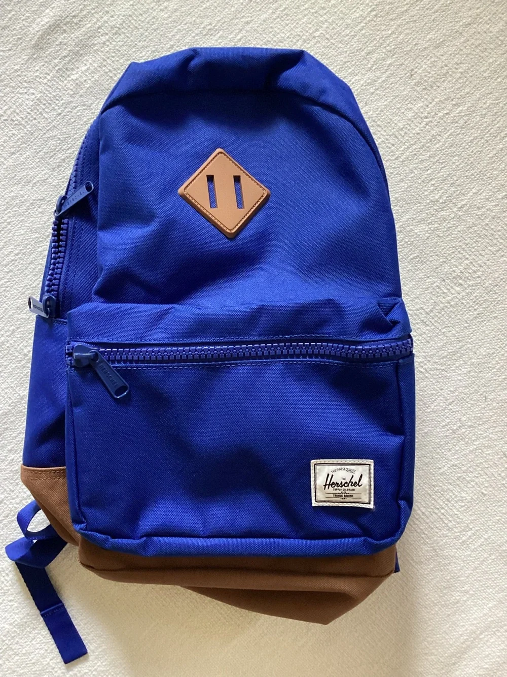 Herschel Supply Co. Heritage youth backpack in a blue and brown colorway.